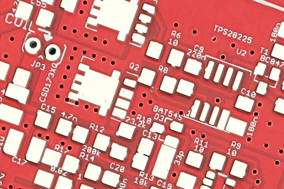 Close-up of a populated automotive-grade printed circuit board with power components