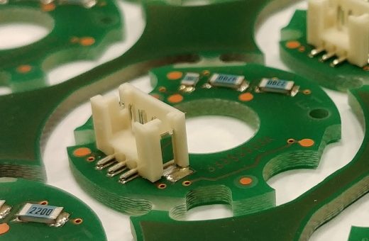 Macro detail of printed circuit board pads, vias, and connector surface finish