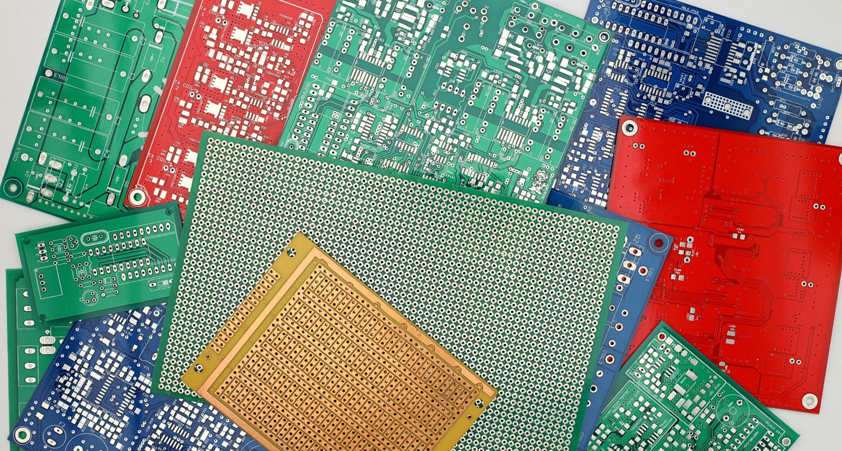 An assortment of colorful prototype printed circuit boards in various stages of design