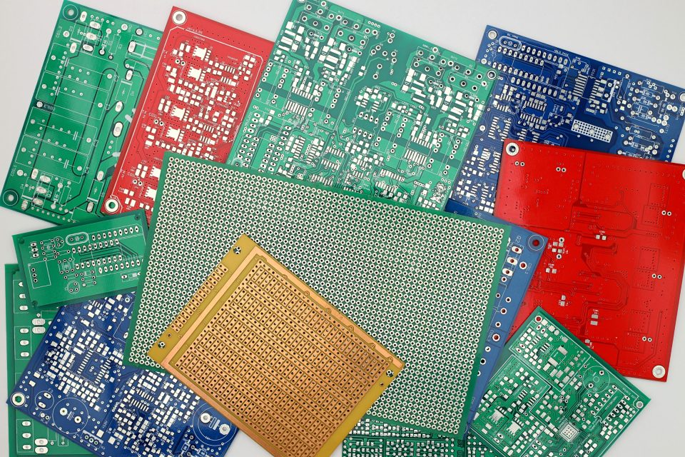 An assortment of colorful prototype printed circuit boards in various stages of design