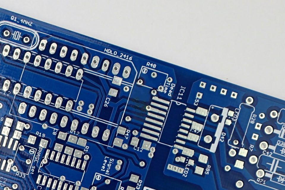Close-up of a populated industrial control circuit board with integrated circuits