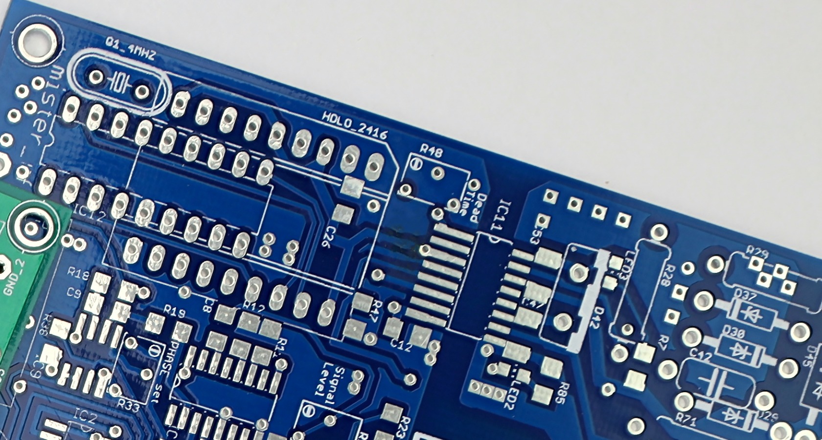 Close-up of a populated industrial control circuit board with integrated circuits