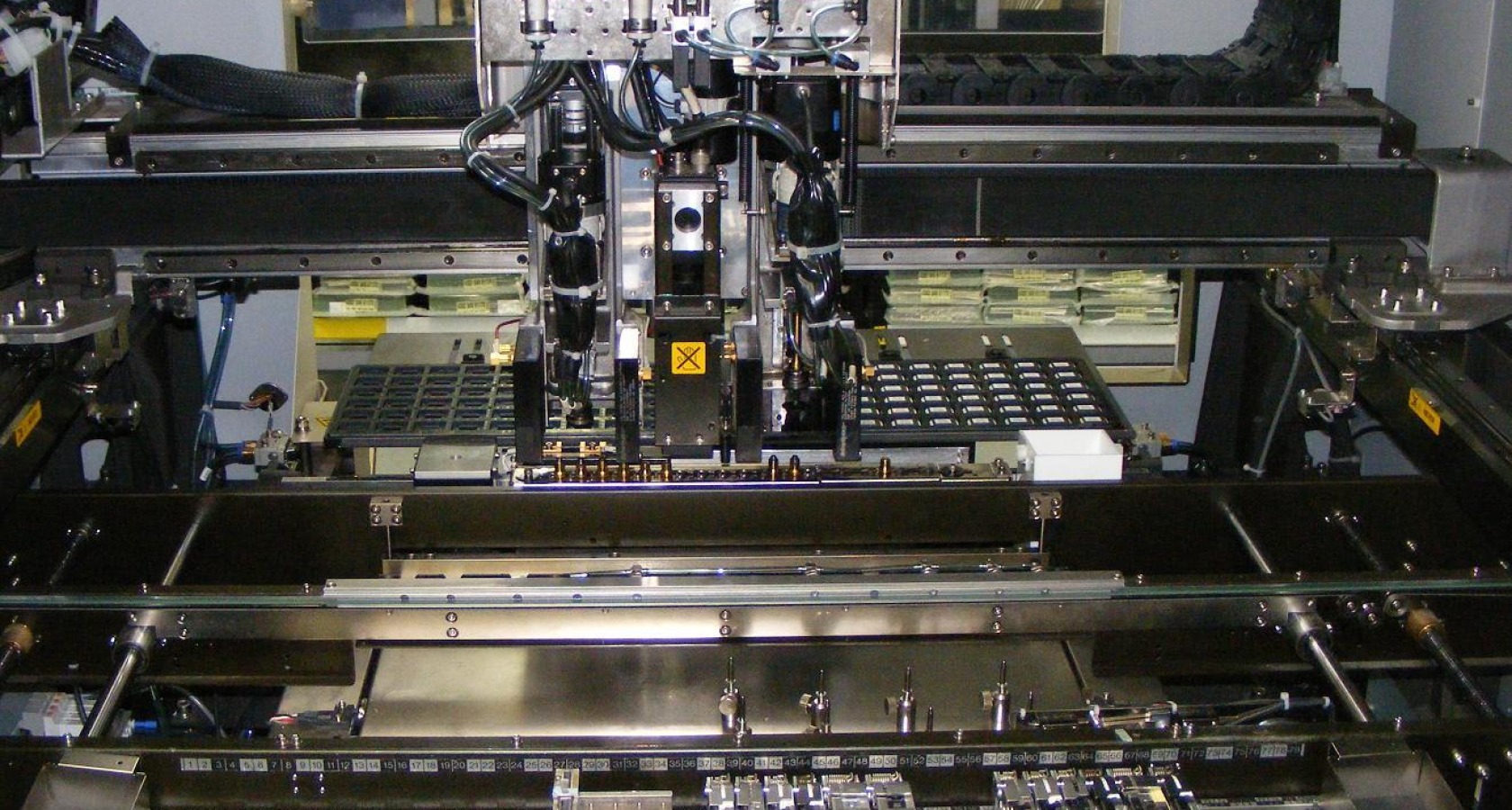 Internals of a surface-mount pick-and-place assembly machine with component tape feeders